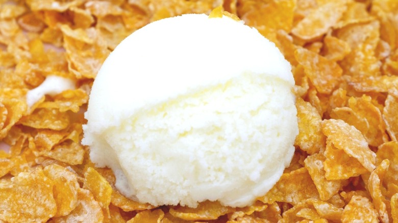 Scoop of white ice cream on bed of corn flake cereal