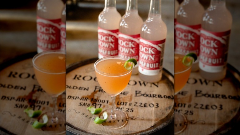 Rock Town Grapefruit bottles on a branded barrel with a cockail.