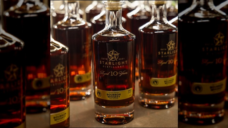 Sleek bottles of Starlight bourbon huddled together.
