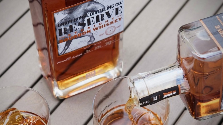 Close-up label shot of Union Horse Whiskey while a bottle is poured into a glass.