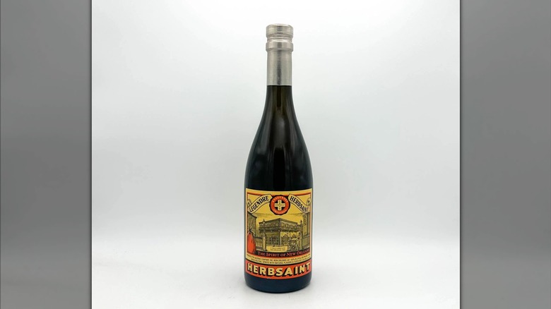Profile shot of a bottle of Herbsaint against white background.
