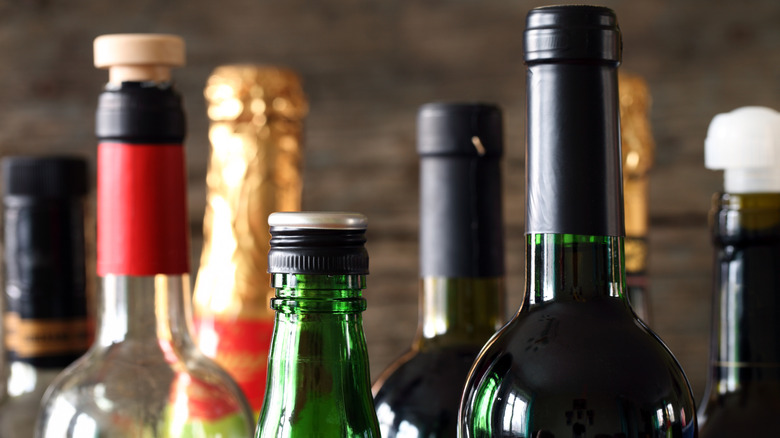 A close-up shot of the bottle necks of various shapes and sizes.