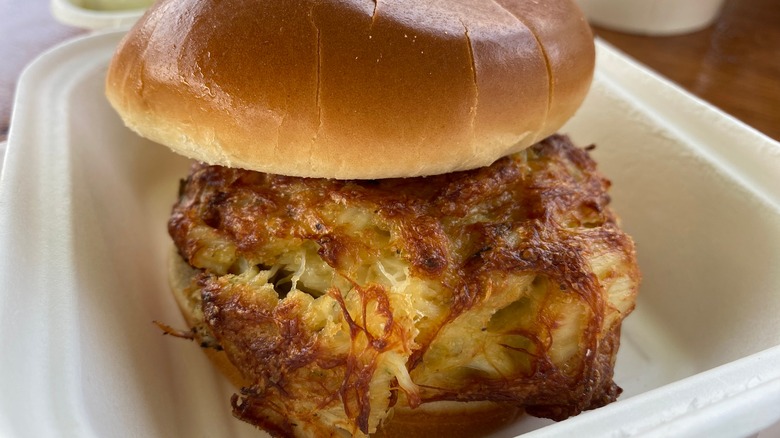 Crab cake sandwich in a takeout container