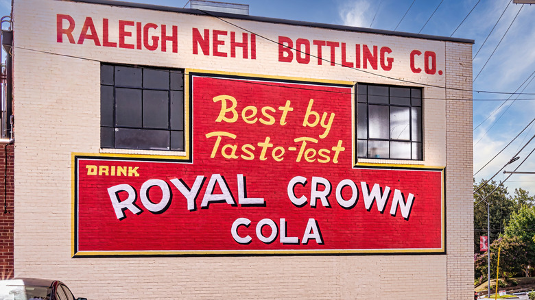 Vintage mural advertising RC Cola outside of a bottling facility.