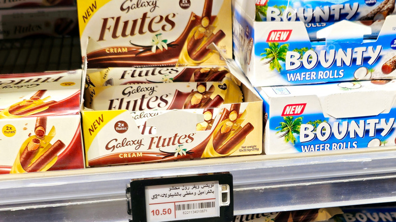 Galaxy flutes and bounty chocolates on grocery store shelf