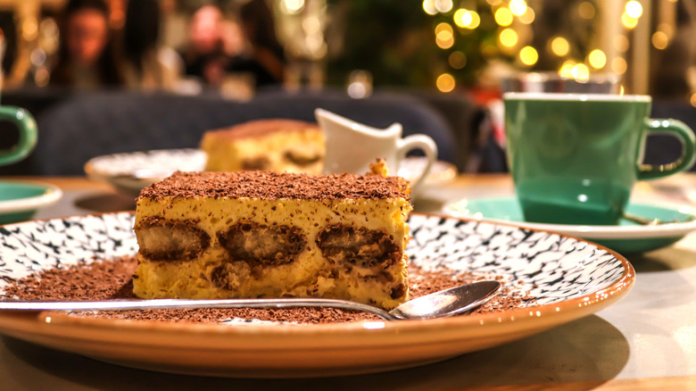 serving of tiramisu with restaurant in background