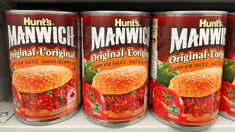 three cans of Manwich on a shelf