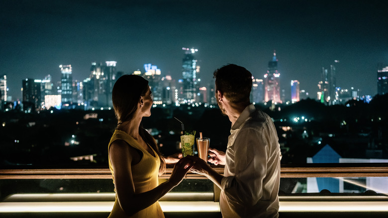two people on rooftop looking at skyline 