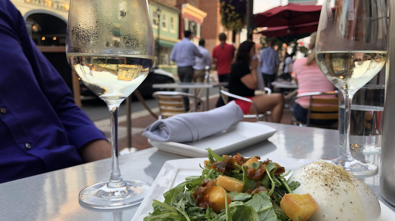 Outdoor dinner and wine glasses at The Wine Kitchen in Leesburg