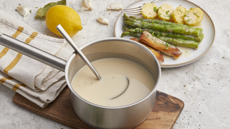 sauce pan of veloute sauce and plate of food