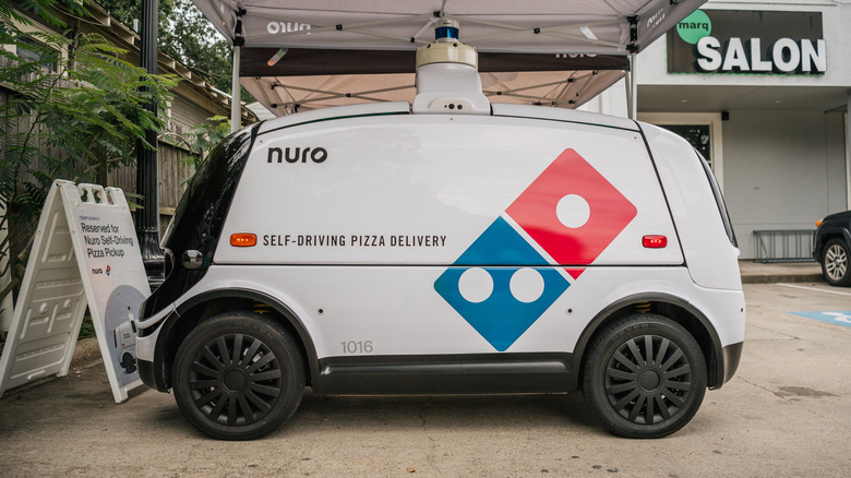 Small robotic car with Domino's logo on the side