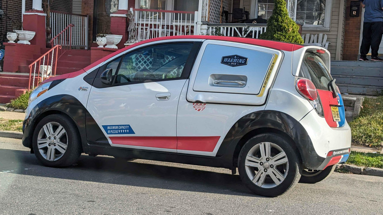 Small Domino's delivery car with a warming oven door on the side