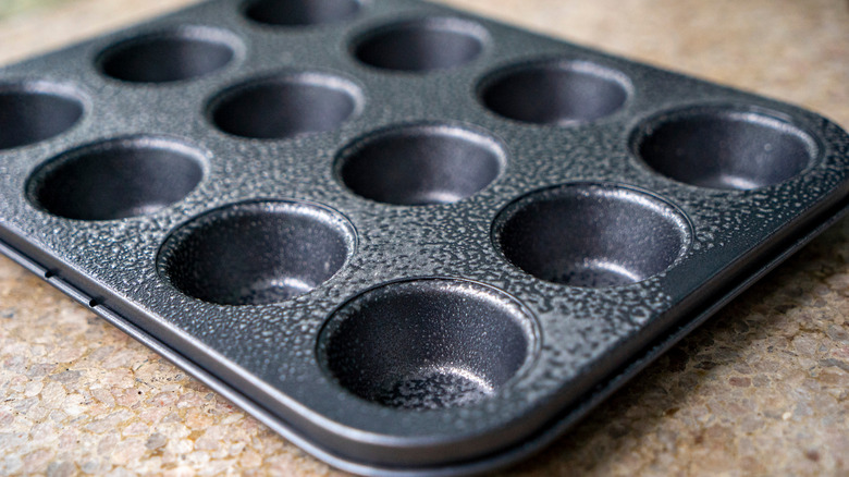 Empty muffin tin on table