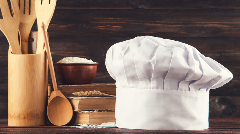 chefs hat with wooden utensils