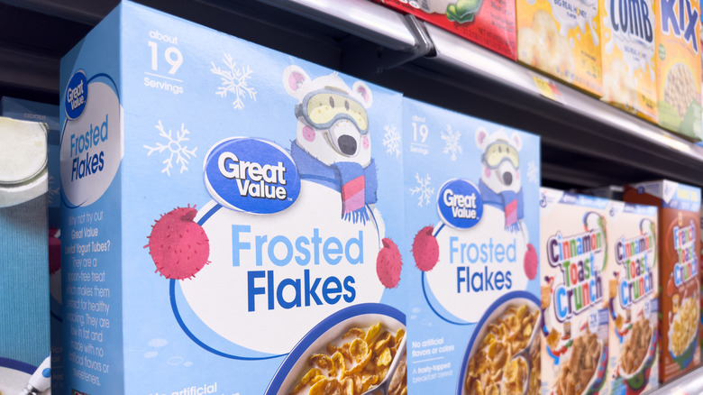 A shelf of cereal at a grocery store, including Great Value Frosted Flakes