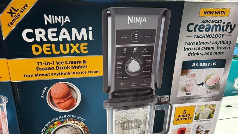 View of Ninja CREAMi on a kitchen counter with ice cream and chocolate Oreo cookies