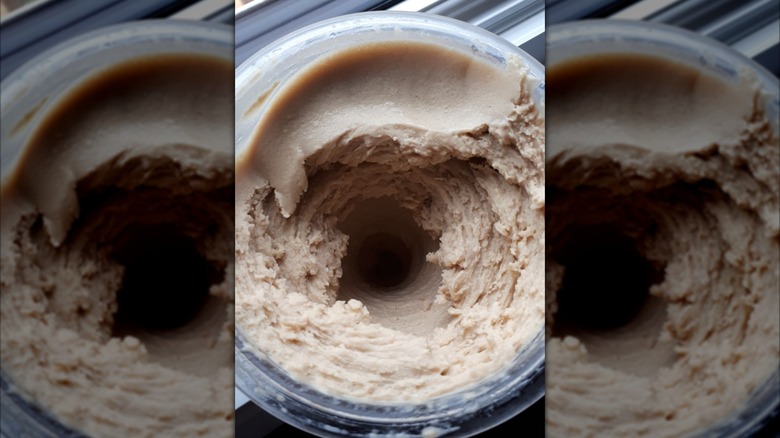Overhead closeup view of creamy frozen dessert in Ninja CREAMi