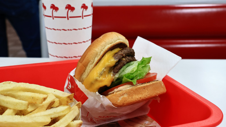 closeup of an in-n-out burger with fries and a drink