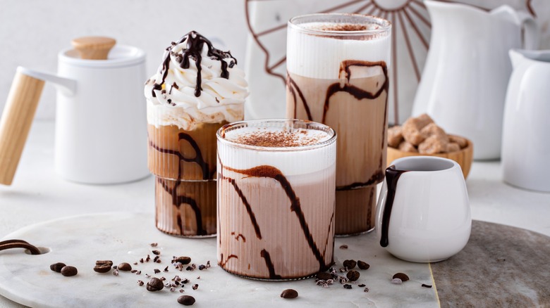 iced coffees with chocolate syrup, whipped cream, cinnamon