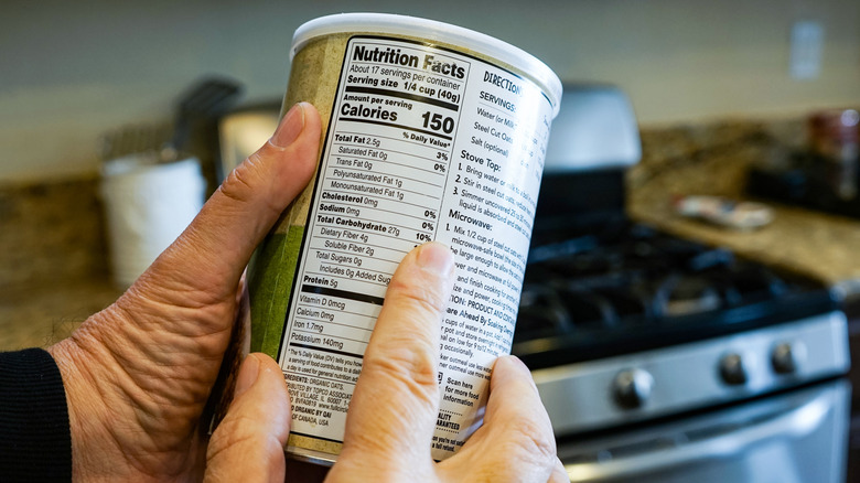 Person pointing at nutritional facts.