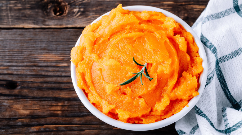 Pumpkin puree in a bowl with rosemary