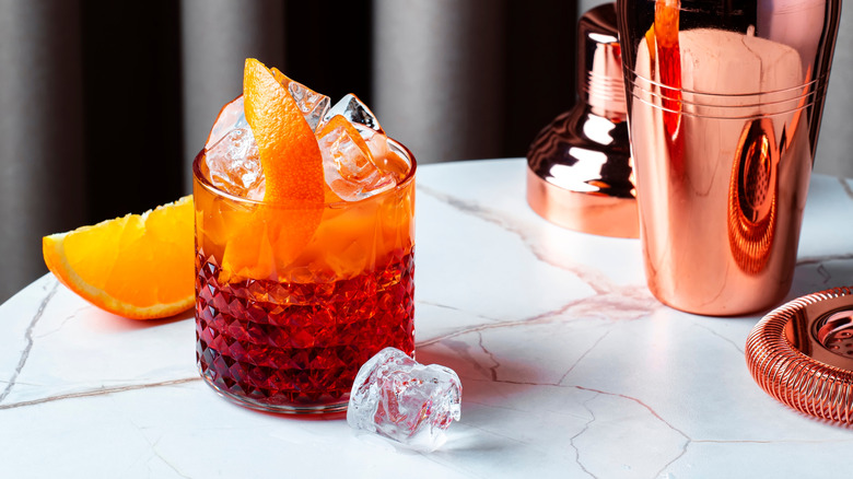 Picon Punch cocktail garnished with orange peel