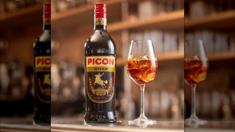 Bottle of Picon Amer beside a glass of liqueur