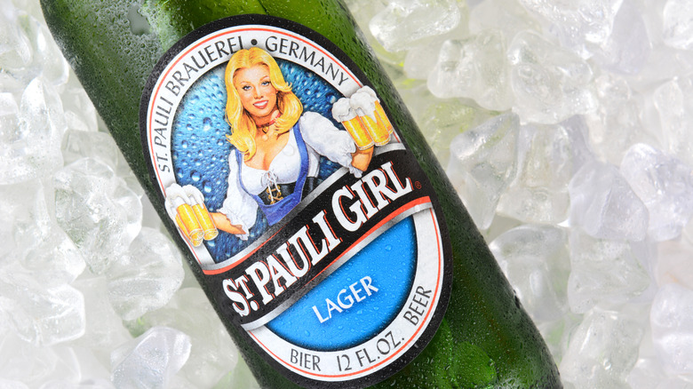 The green bottle of St Pauli Girl lager featuring the image of a Tavern girl with blonde hair holding several pints of beer