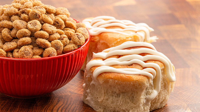 Cinnamon bun breakfast cereal in red bowl with pastries