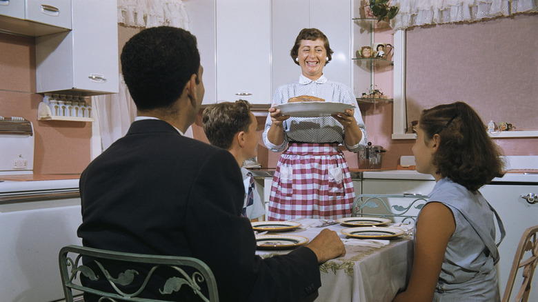 vintage photo of Housewife Bringing Dinner to Table