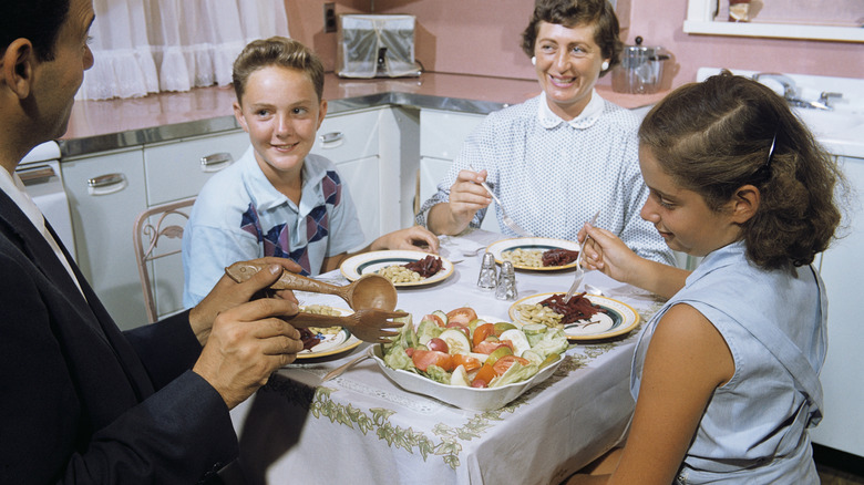 vintage photo of family eating dinner in kitchen