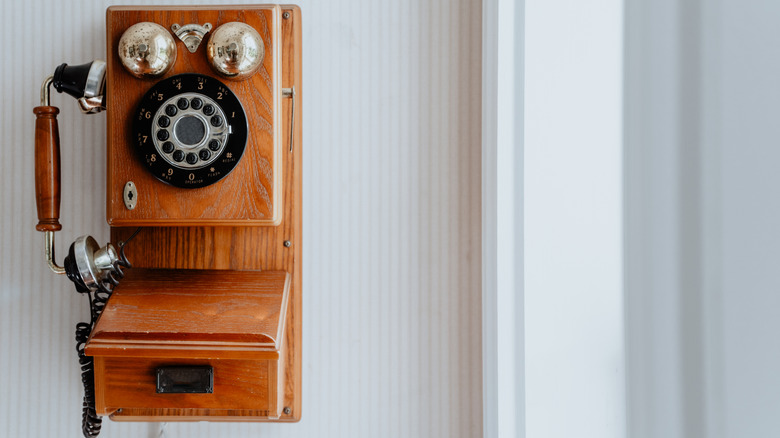 vintage rotary phone mounted on wall