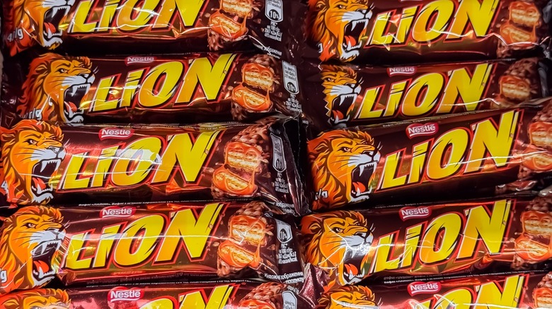 A box of nestle lion bars in their rappers, featuring a lion logo in the name in yellow
