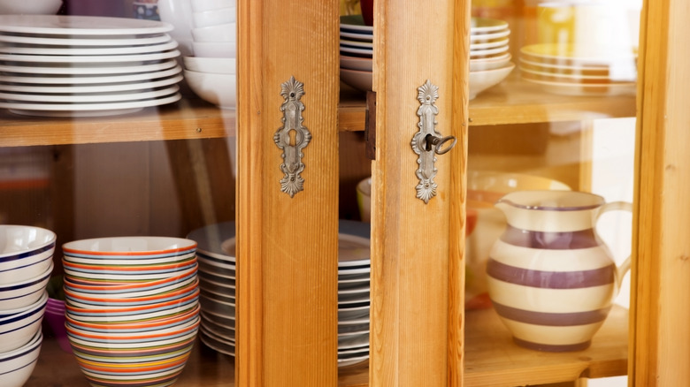 Close-up of a vintage China hutch filled with dishware