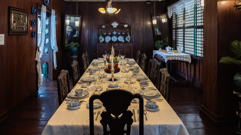 Cozy retro home dining room interior with China hutch at the far end of the table