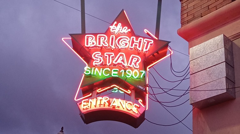 Star-shaped neon sign lit up at night outside the Bright Star Restaurant