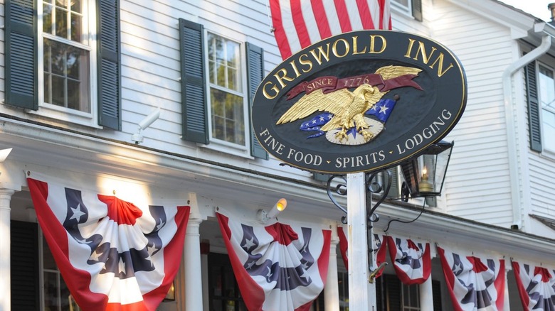 The sign outside the Griswold Inn, which is decorated with American flags and banners for Independence Day