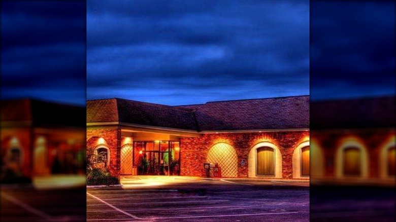 Outside The Plaza Restaurant & Oyster Bar at night with lights glowing on the walls