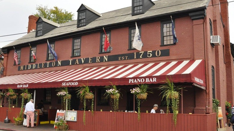Outside Middleton Tavern with flags and outdoor patio seating