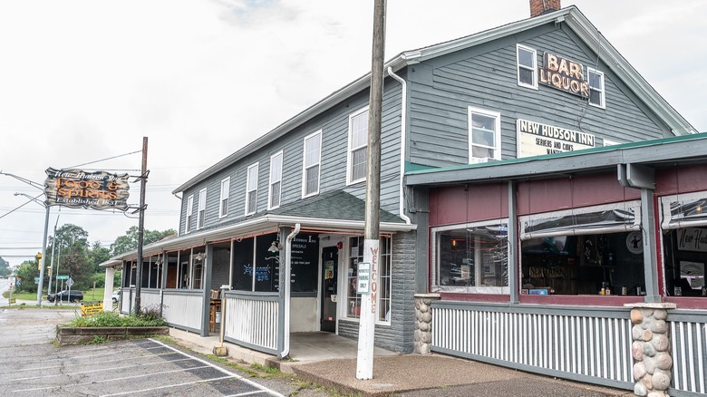 Outside New Hudson Inn with parking lot