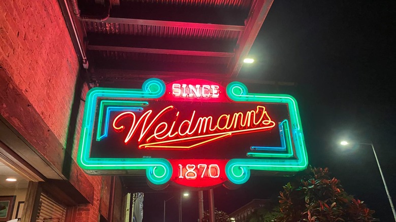 Weidmann's neon sign lit up outside at night