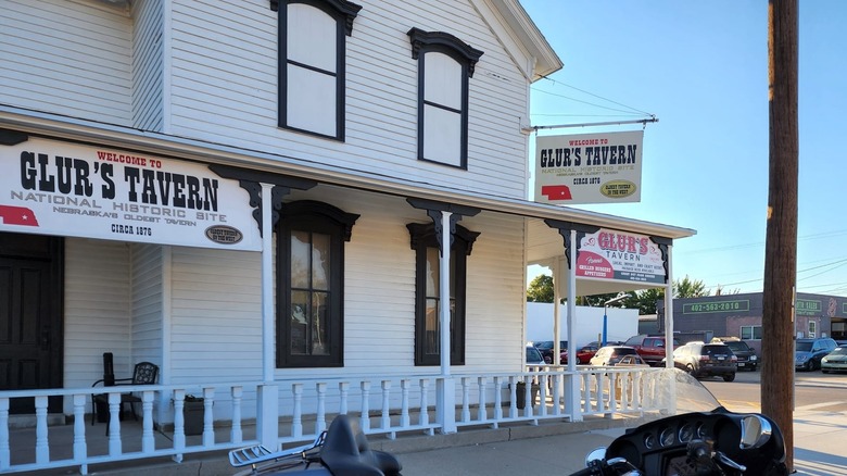 Outside of Glur's Tavern with wrap-around porch