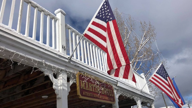 Martin Hotel sign below balcony with American flags and twinkle lights