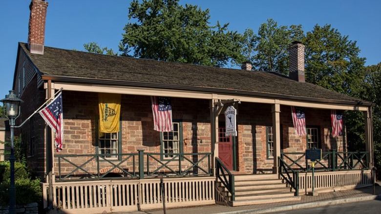 Outside Old '76 House with a variety of U.S. flags flying