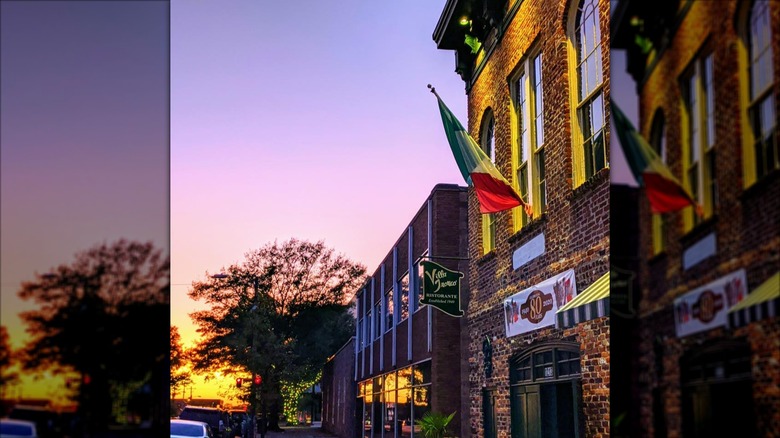 Outside Villa Tronco Italian Restaurant at sunset with Italian flag