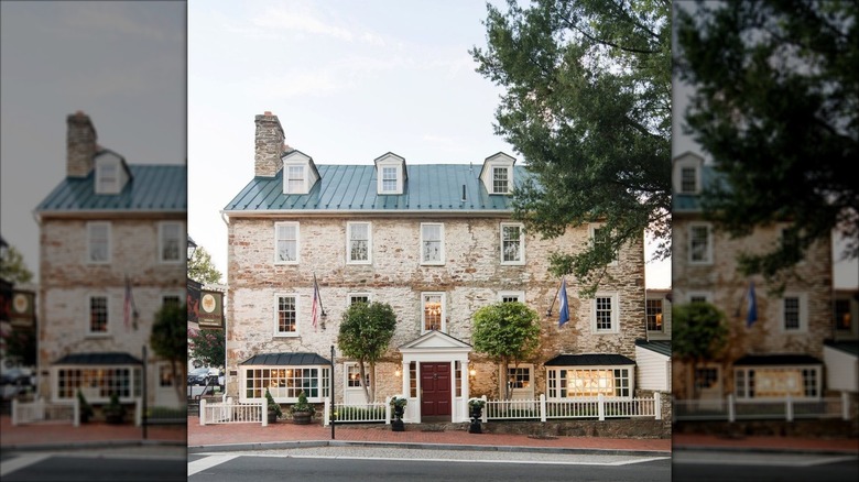Outside view of the REd Fox Inn & Tavern with lit windows during the day