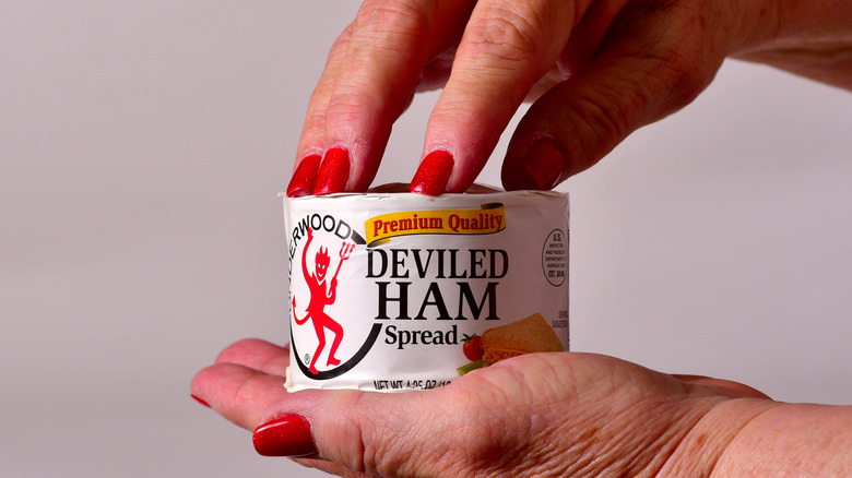 person holding a can of Underwood Deviled Ham Spread