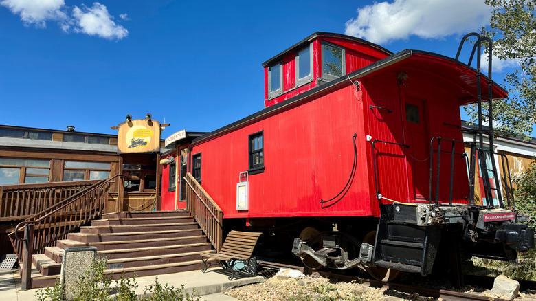 a railroad themed restaurant with a red train car