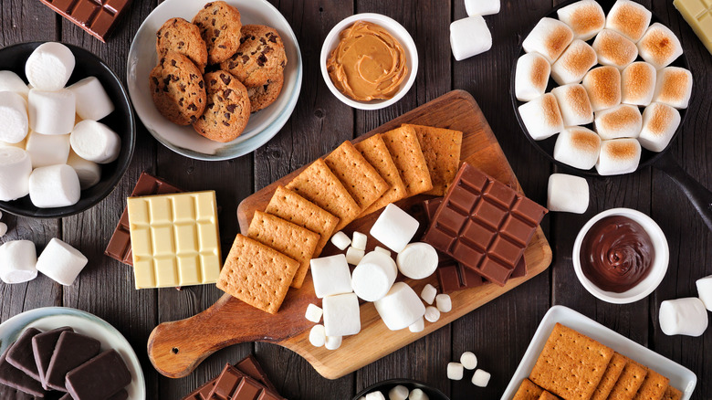 An assortment of s'mores ingredients, including the standards as well as peanut butter, chocolate chip cookies, and white chocolate.
