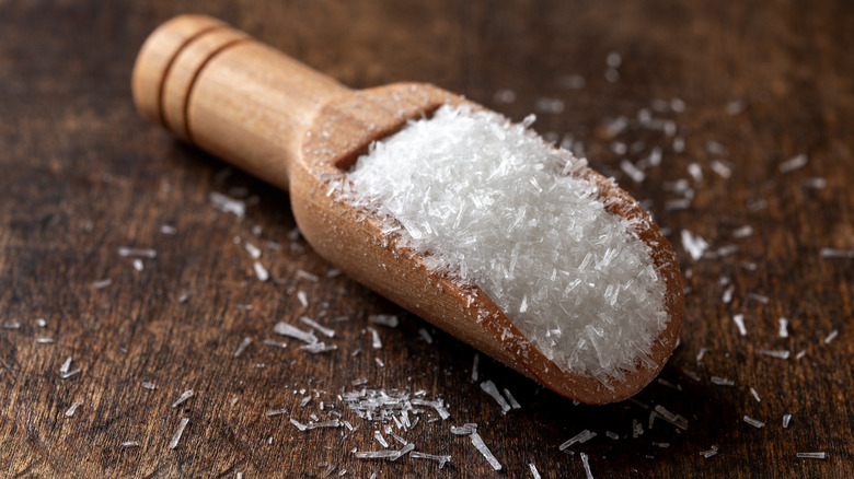 close up of MSG crystals on a wooden scooper